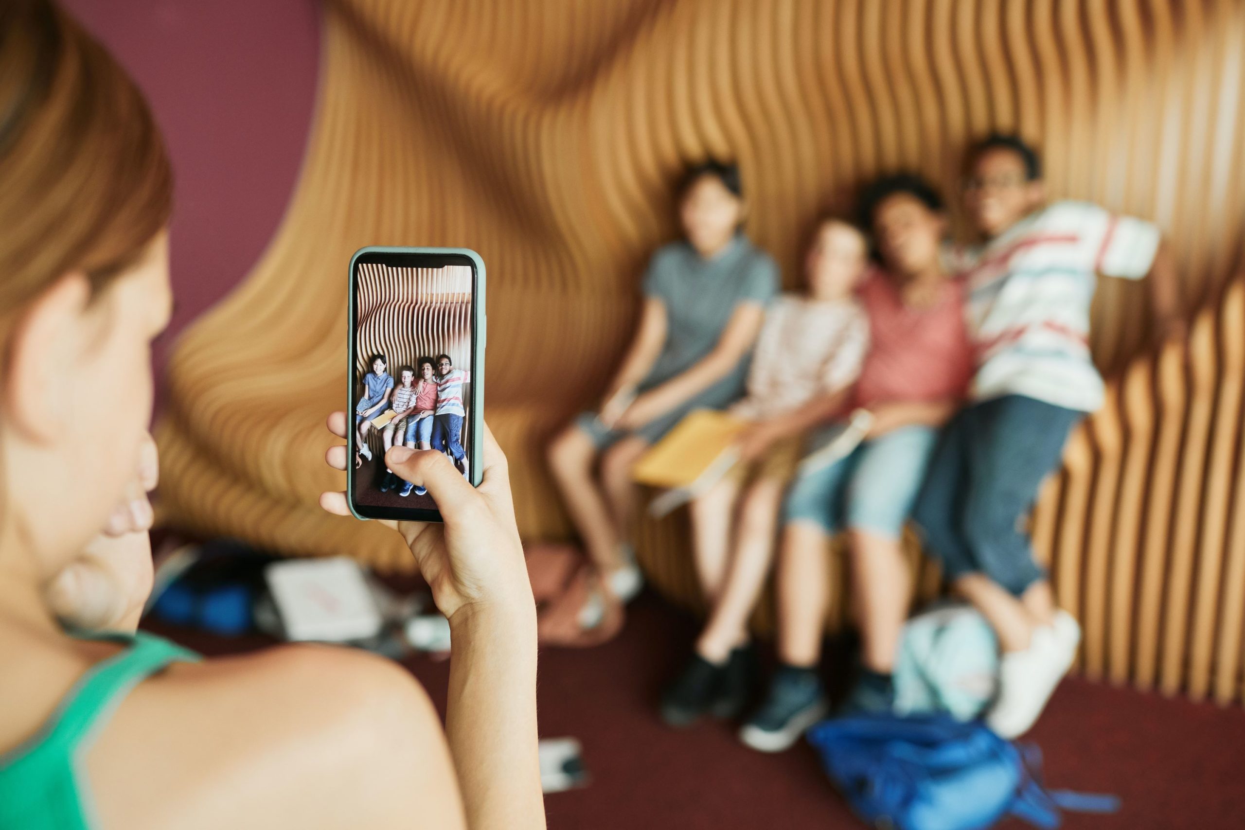 girl taking a smartphone photo of friends