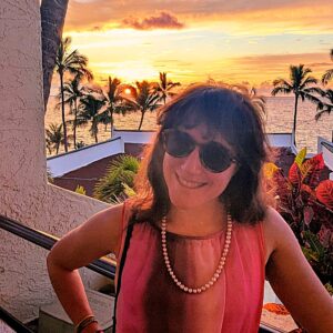 Rachel Rifkin outdoors at sunset, wearing sunglasses.